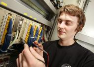 Apprentice working on computing network hardware
