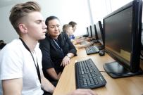Student and tutor working together on computer 